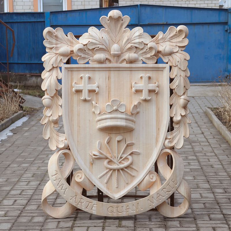 Wood carving. Coat of arms. Carved crest made of linden (basswood) wood