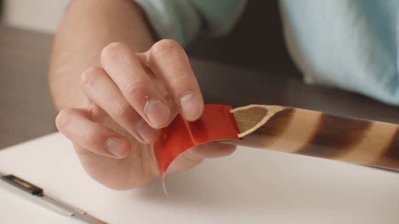 ...checks that the piece of can is held in the slit...
