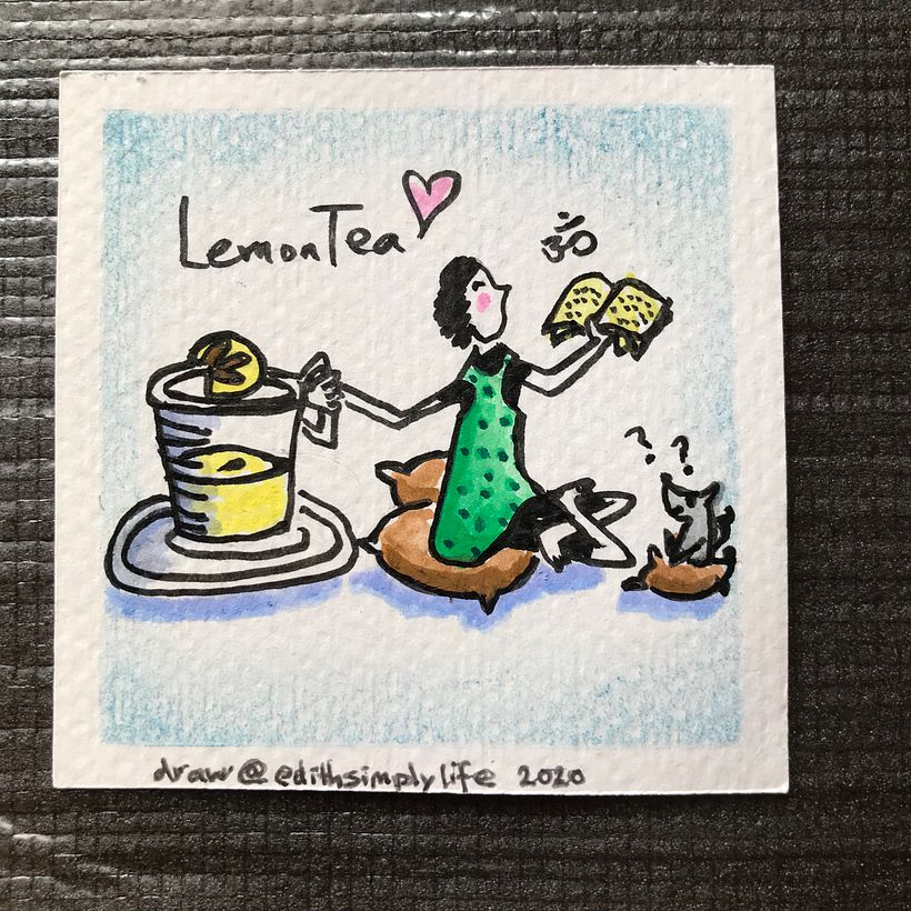A girl reading yoga book to her dog at home sipping her favourite lemon tea