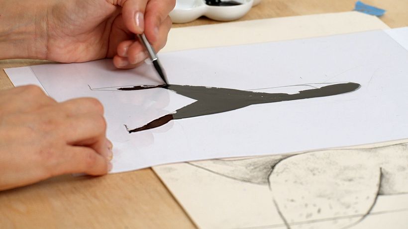 Fill the body of the character on the acetate with the ink and a brush