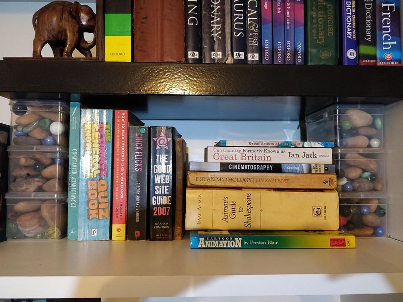 Shelf on containers containing pebbles and marbles