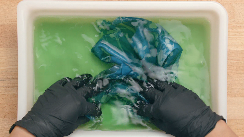 Rinse off any excess dye by soaking the fabric in water