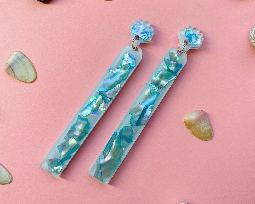 Abalone shell earrings with blue pigment.