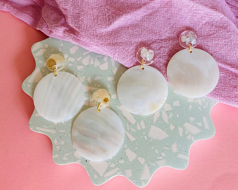 Resin studs with mother of pearl pieces with mother of pearl disks.