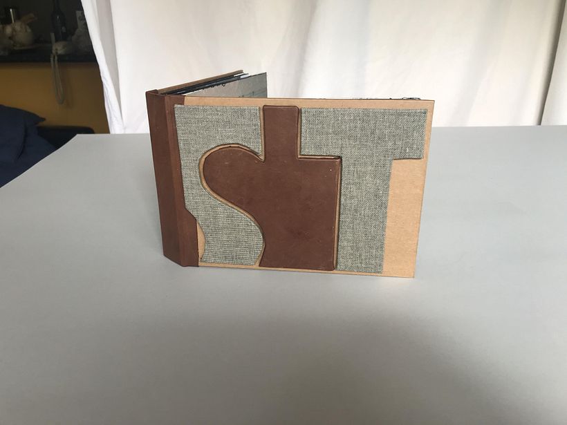 Front Cover (consists of cardboard, grey textured book cloth, Kangaroo leather, craft paper)
