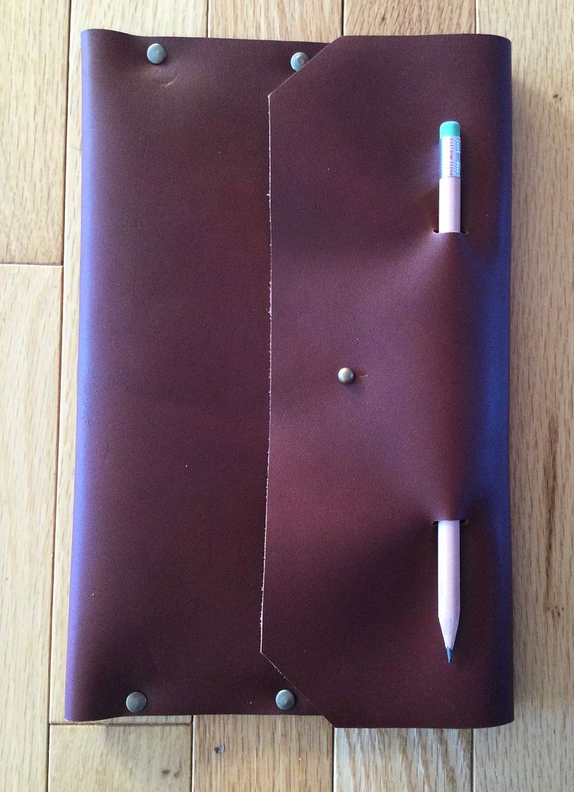 Folded leather notebook ‘sleeve’ with built in pencil holder.