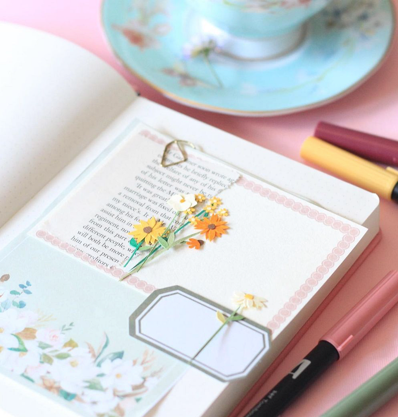Hannah’s notebooks feature mini paper flowers.