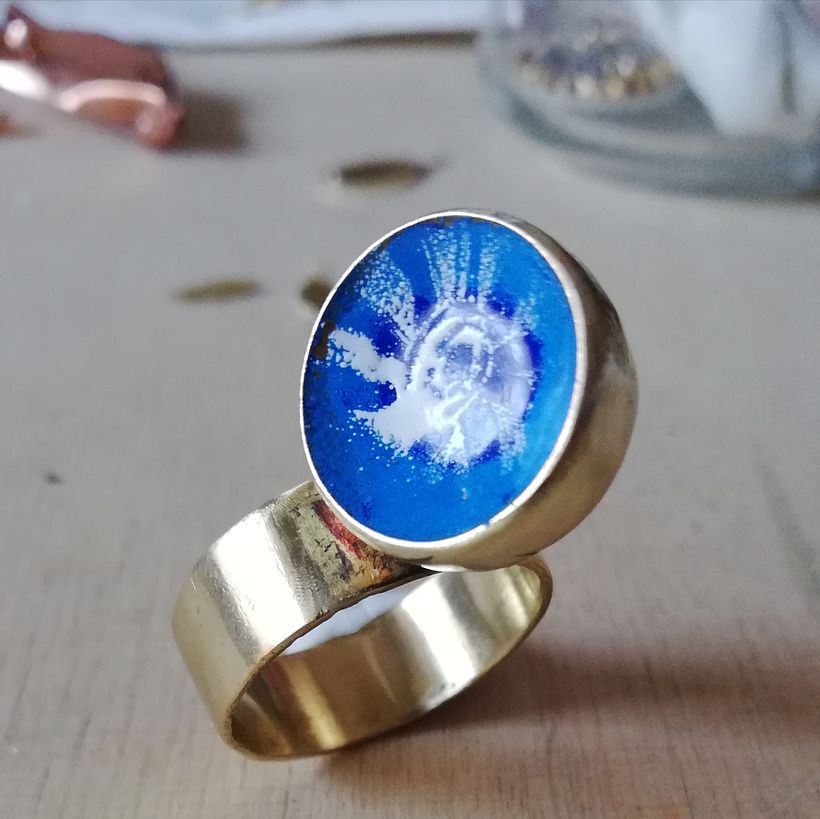 Anillo hueco de latón decorado con esmalte en frío.