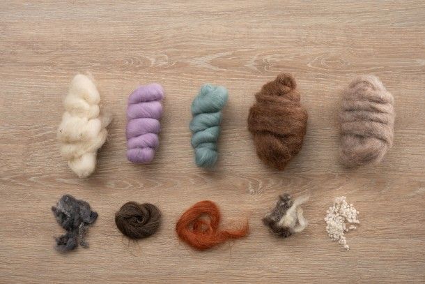 Juanamatú (Katerin J Gómez) displays the materials needed for creating needle felting dolls.