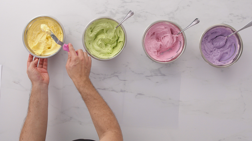 Divide the mixed icing into four bowls to create the colors you’re going to use for your marbling.