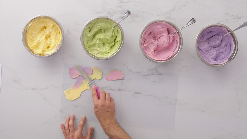 Spread a little bit of butter cream onto the acetate.