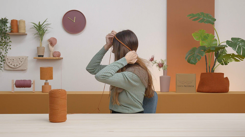 Pass a chain around the bottom of your head and fasten it like a headband.