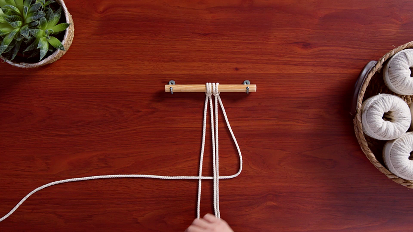 Pass the right hand working cord underneath the middle filler cords to make a reverse number 4.