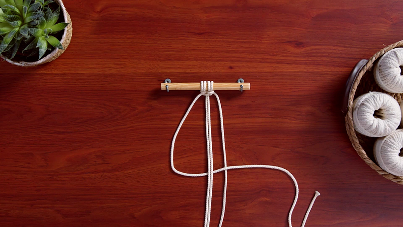 Pass the left hand working cord below the middle fillers to make a number 4.