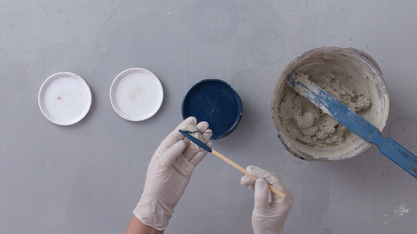 Make a roll out of the concrete and color it with a stick dipped in vinyl.