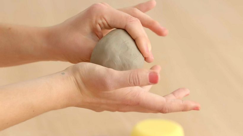 Create a hole in the clay with your thumb