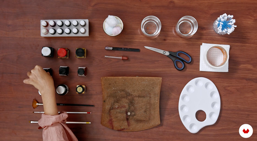 Carine Wallauer's work table displaying the materials required for applying watercolor techniques to photographs.
