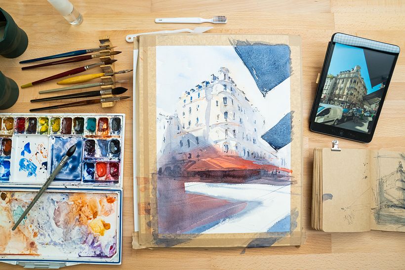 Sketchbook and watercolor materials.