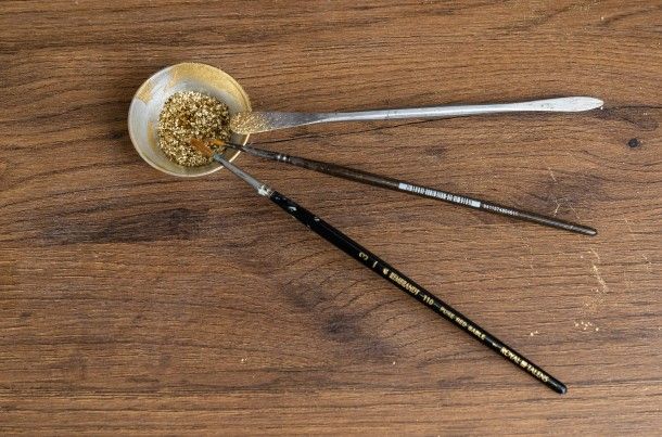 Various paintbrushes and gold powder.