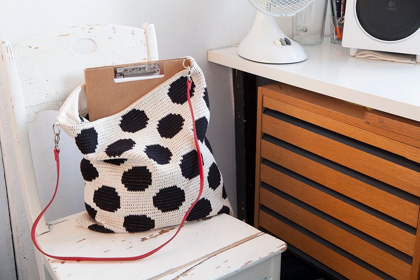 Dotty tote bag with a leather handle.