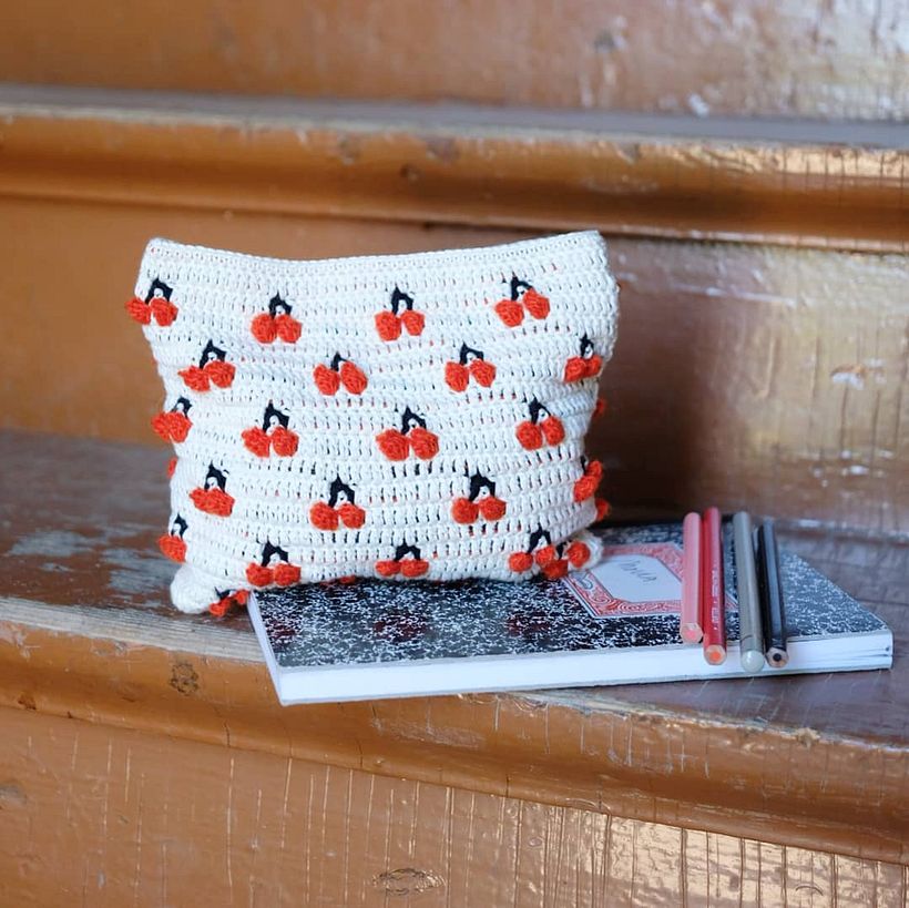 Small cherry pouch made with popcorn stitch.