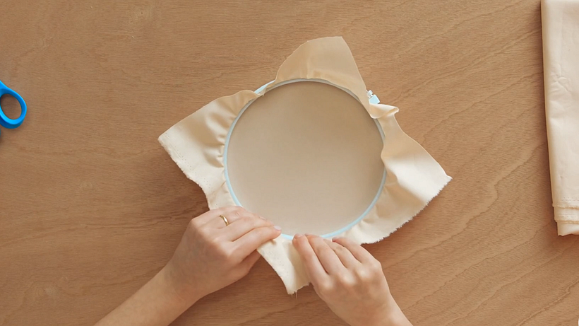 Pull the fabric to create tension