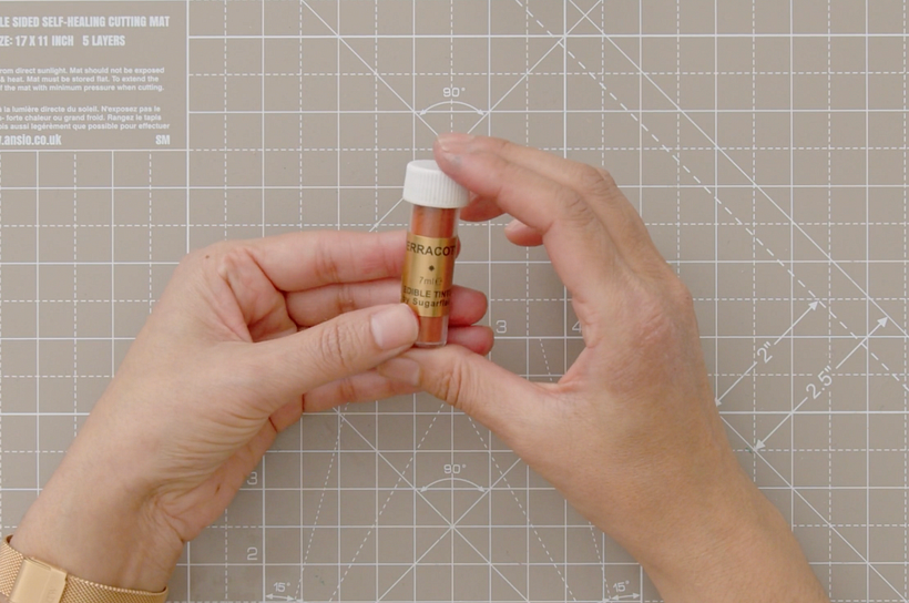 Edible terracotta-colored powder.