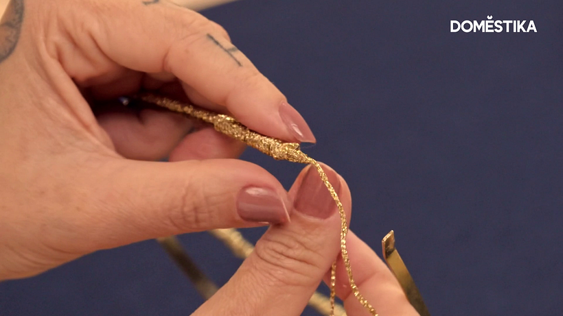 Apply a touch of glue to fix the thread in place and provide a finishing touch.