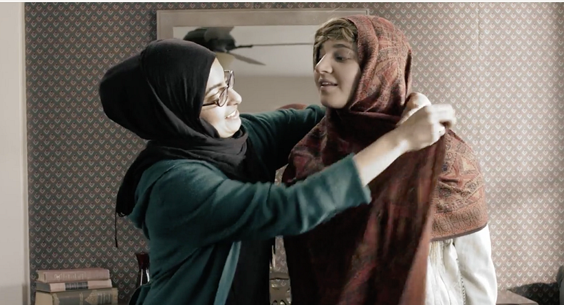 The character Apple at Sabah's house learning how to wear a Hijab.
