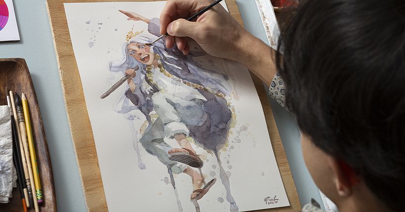Geoff creating manga in watercolor, working with essential materials.