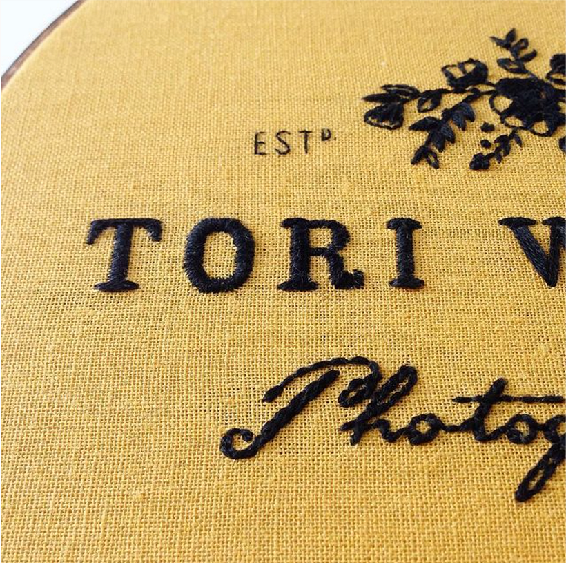 Hand embroidered logo for Tori Watson Photography. Cotton on linen in 9" stained hoop.