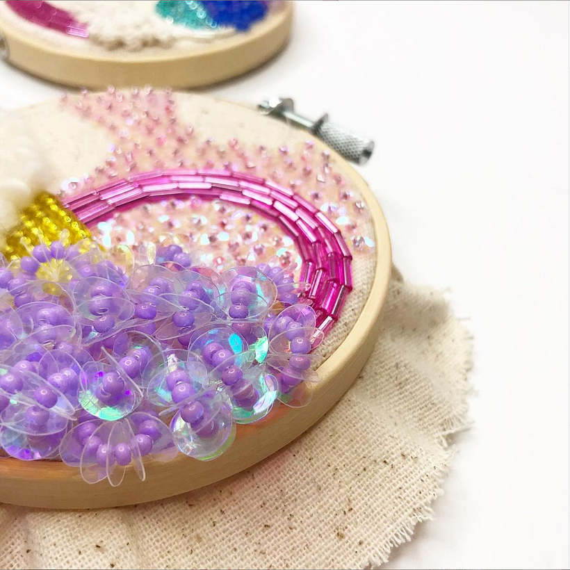Hand beaded "Otherworldly" hoops. Mixed beads and thread on cotton.