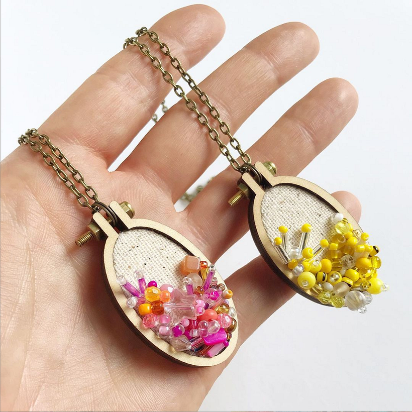 "Color Theory" hand beaded necklaces. Made from recycled beads. Framed in a wooden hoop with brass chain and findings.