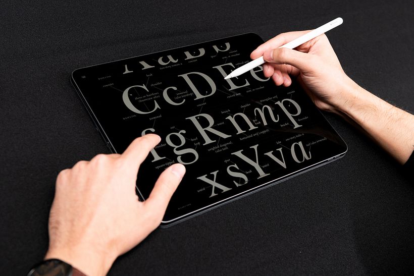 Eduardo Mejía studying the strokes that make up each letter.