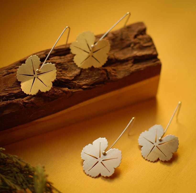 Oorbellen geïnspireerd op het blad van kaasjeskruid, gemaakt van alpaca of brons met een zilveren takje.