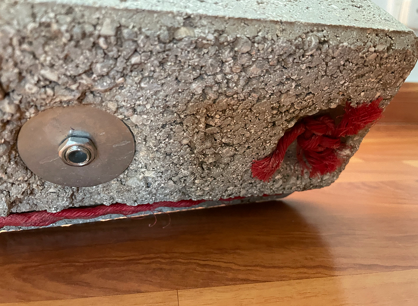 Made use of the two holes in the brick. One for rope to create tension, and the other I used the old lamp parts.