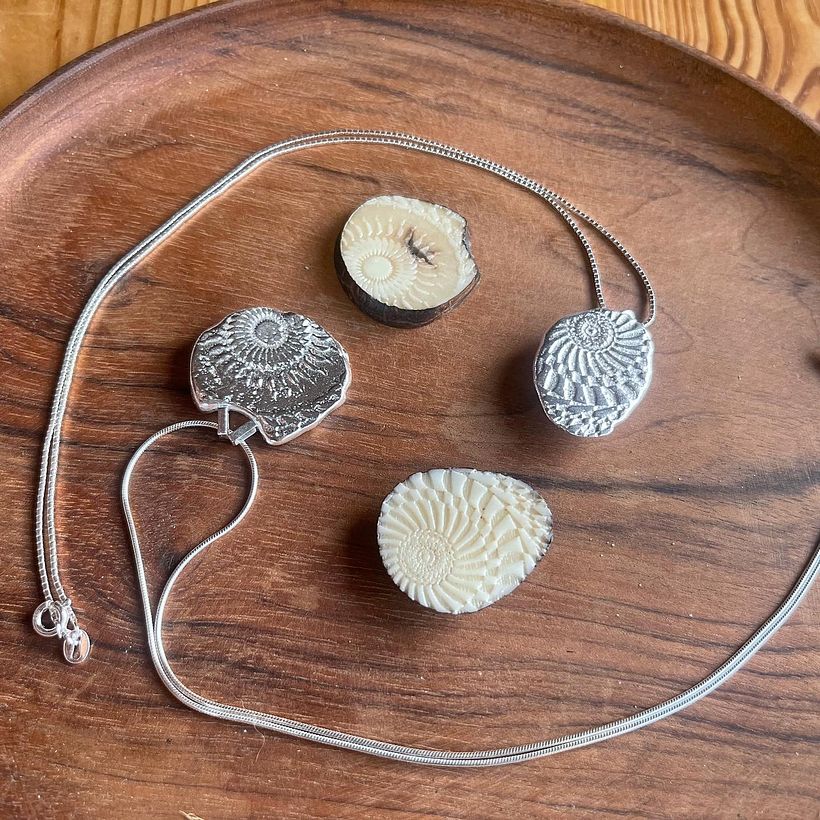 Tagua slices laser cut and then sandcasted into silver to make pendants