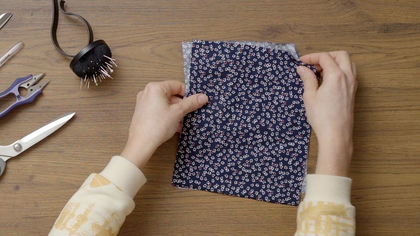 Place the two pieces of fabric back to back