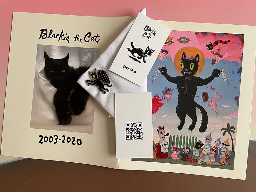 Memorial booklet, enamel pin, handkerchief, and card with QR code (no longer valid) to listen to Blackie's purr.