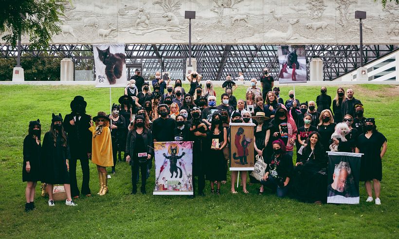 Group shot of memorial attendees, many wearing Blackie hats. Photo by the1point8