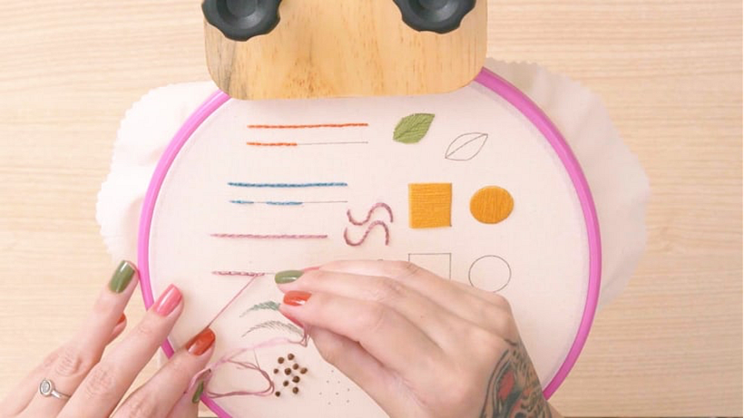 Push the needle through the center of the stitch and return to the same hole. Then trim away any excess thread