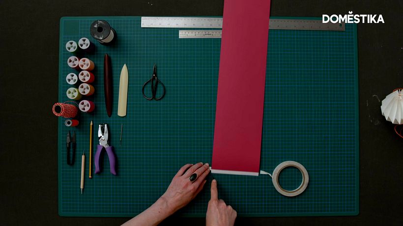Stick the double-sided tape to one end of your paper