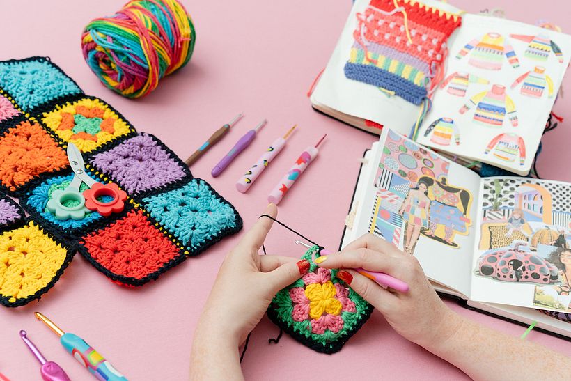 Traditional granny squares use different colors of yarn for each row and are edged in a black border.