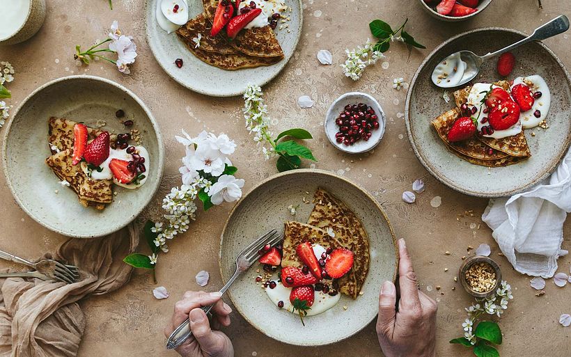 Consider how the circular plates are arranged, and how the triangular crêpes are broken up with smaller shapes.