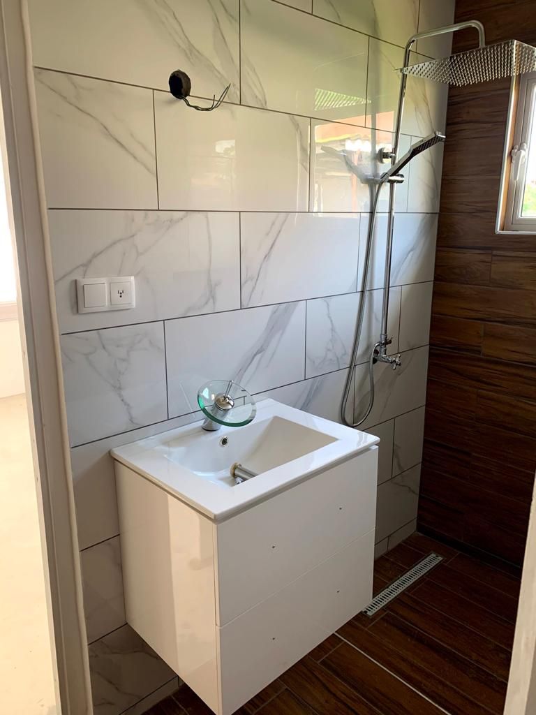 In the old bathroom was the toilet were the in is now and the sink was were to toilet is now. 