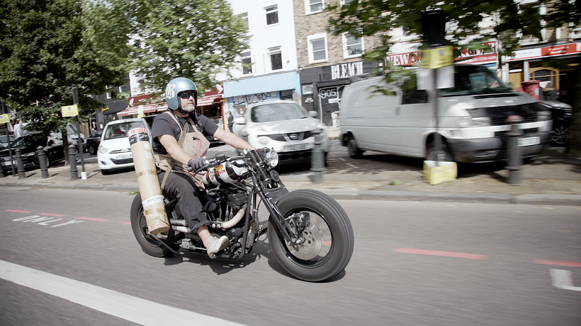 Dave delivers prints on his motorbike. 
