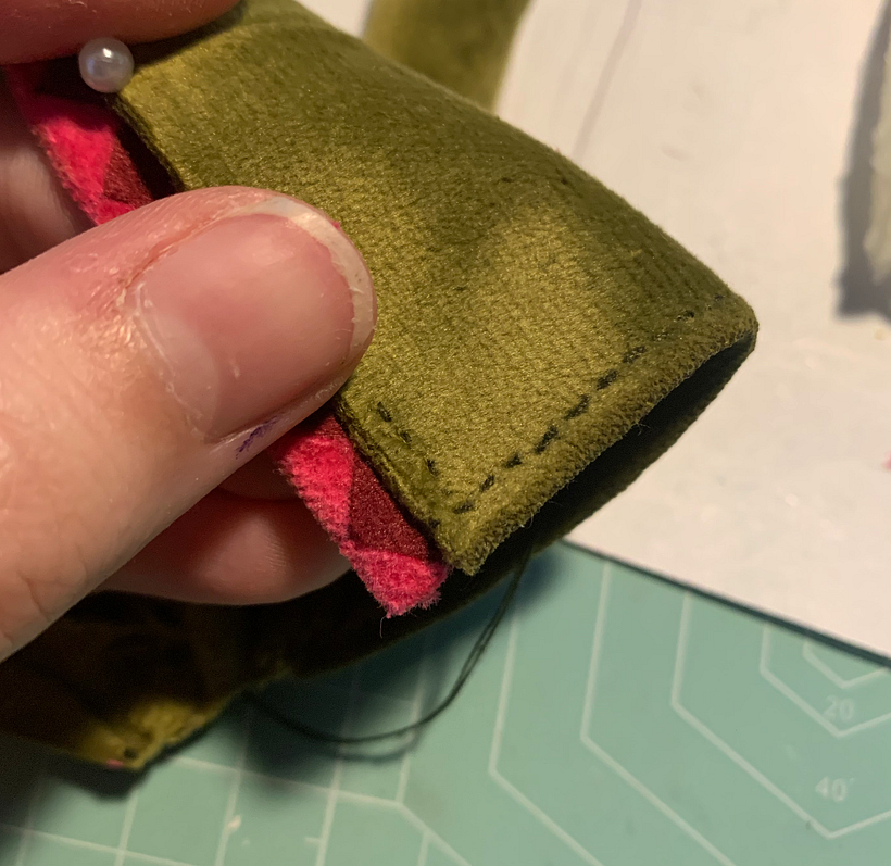 Sewing the coat trim on.
