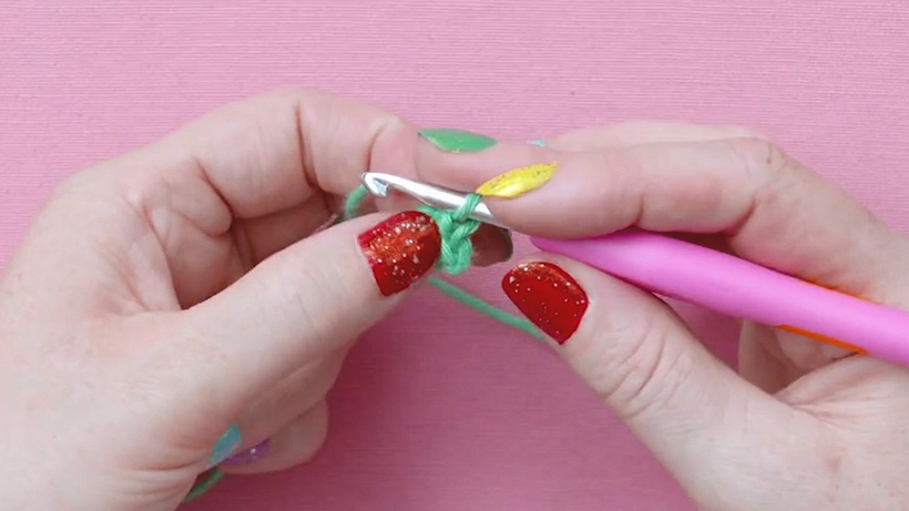 Loop the yarn around your hook and pull through both stitches for the central ring
