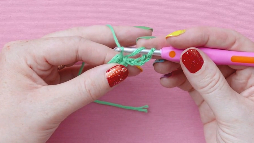 Once you have three loops on your hook, wrap your yarn over and pull through two of the loops.
