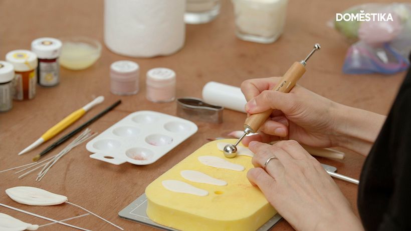 She gently rolls over the edges with her ball tool to create a realistic finish